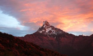 Sunset clouds glowing around Fishtail Mountain during the Mardi Himal Base Camp trek, part of the Fishtail Mountain Trek with Life Happens Outdoors