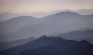 Endless Himalayan ridgelines fading into the distance at sunset during the Mardi Himal trek on the Fishtail Mountain Trek with Life Happens Outdoors