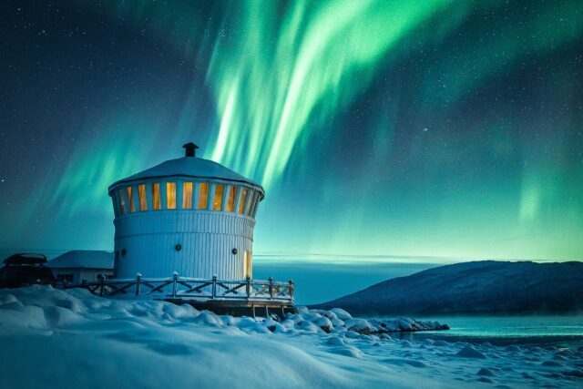 The northern lights blasting above our accommodation on the Arctic island of Senja during the Chase the Northern Lights Expedition with the Life Happens Outdoors team.