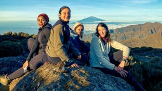 Life Happens Outdoors female trekkers on the Kilimanjaro trail from Shira Camp to Lava Tower, soaking in a stunning sunrise.