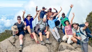 Life Happens Outdoors climbers at a scenic viewpoint above Machame Camp en route to Shira Camp on day two of the Mount Kilimanjaro climb.