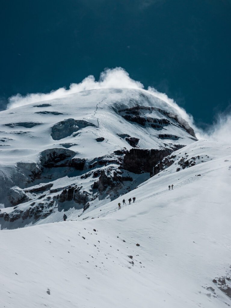 The Life Happens Outdoors team approaching Chimborazo Base Camp with the Ventimilla summit visible high above during the Climb Cotopaxi & Climb Chimborazo Expedition.