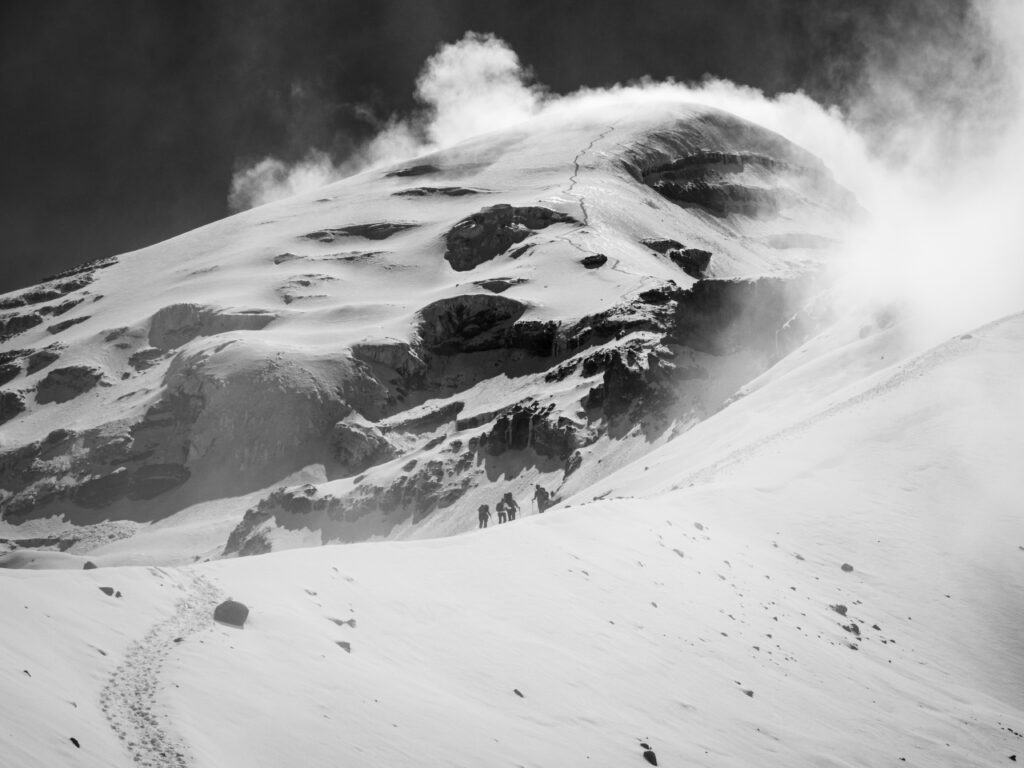 The Life Happens Outdoors team approaching Chimborazo Base Camp with the Ventimilla summit visible high above during the Climb Cotopaxi & Climb Chimborazo Expedition.