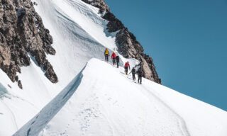 The Life Happens Outdoors team climbing the third mogul (Third Boss) on the summit ridge of the Mont Blanc during the Mont Blanc Summit Climb course.