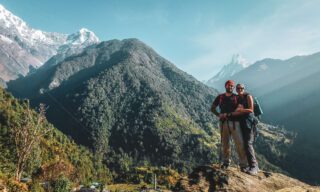 Life Happens Outdoors team members trekking to Dovan with Machapuchare and the Annapurna Valley behind them during the Annapurna Base Camp Trek.