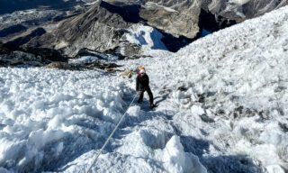 LHO climber Melissa Jefferies ascending the first set of fixed ropes on the glacier, surrounded by ice pinnacles formed by wind and dry conditions during the Lobuche East climb expedition.