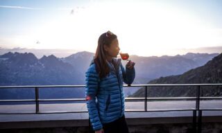 Catherine Choy enjoying a glass of wine at the Albert 1ère Hut above Le Tour Glacier on the first night of the Chamonix to Zermatt Haute Route Expedition with the Life Happens Outdoors team.