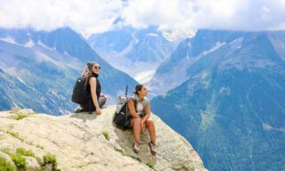 Sitting on the rocks of Aiguilles d'Argentière during the Chamonix Valley Treks, the Best Day Hikes Around Mont Blanc with the Life Happens Outdoors team.