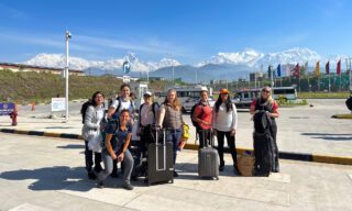 The Life Happens Outdoors team arriving at the new Pokhara Airport with stunning views of the entire Annapurna Range in the background during the Annapurna Base Camp Trek.