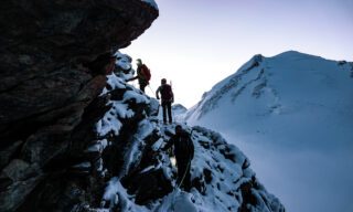 IFMGA guide and Piolet d'Or winner Fred Degoulet leading our team at sunrise to the summit of the Pollux during the Spaghetti Tour Expedition Climb Monte Rosa with the Life Happens Outdoors team.