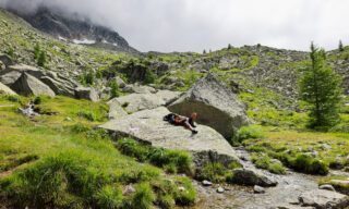 Enjoying the sunshine on the boulders of Flégère above Chamonix Les Praz during the Chamonix Valley Treks, the Best Day Hikes Around Mont Blanc with the Life Happens Outdoors team.