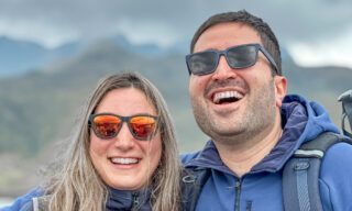 LHO adventurers trekking through Cotopaxi National Park, with sweeping views of high-altitude plains and the snow-capped Cotopaxi Volcano in the distance.