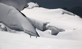IFMGA guide Philippe Genin leading veteran climber Haneen Alsliman across the Monte Rosa Glacier on the way to Capanna Margherita on the summit of Punta Gnifetti during the Spaghetti Tour Expedition Climb Monte Rosa with the Life Happens Outdoors team.