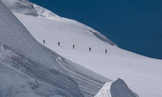 The Life Happens Outdoors team crossing the glacier between Ludwigshöhe and Parrotspitze during a day of summit bagging on the Spaghetti Tour Expedition Climb Monte Rosa with the Life Happens Outdoors team.