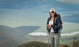 LHO adventurers trekking through Cotopaxi National Park, with sweeping views of high-altitude plains and the snow-capped Cotopaxi Volcano in the distance.