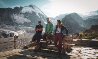 IFMGA guide Gregoire Sauget chatting with LHO co-founder Ghida Arnaout and LHO veteran Anthony Mezher outside the Schönbiel Hut on the last night of the Chamonix to Zermatt Haute Route Expedition with the Life Happens Outdoors team, with the Dent d'Hérens in the background.