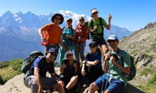 The Life Happens Outdoors team at Les Possettes above the town of Le Tour, with Mont Blanc and the Chamonix Valley in the background during the Tour du Mont Blanc (TMB).