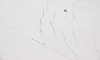 The Life Happens Outdoors team crossing the crevasse splinters on the way to Refugio Gnifetti, as seen from the summit of the Naso del Lyskamm during the Spaghetti Tour Expedition Climb Monte Rosa with the Life Happens Outdoors team.