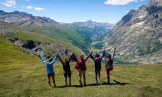 The Life Happens Outdoors team looking out over the Val d'Entrèves from the Grand Col Ferret during the Tour du Mont Blanc (TMB).