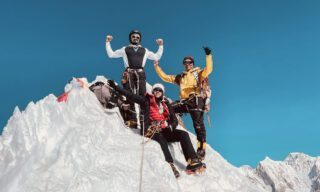 LHO summiteers Zeid Shair and Melissa Jefferies celebrating on the summit of Lobuche East, with stunning panoramic views of the Himalayas in the background.