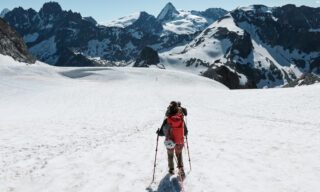 The Life Happens Outdoors team descending on the Trient and d'Orny glaciers, with the Valais Massif ahead of them in full view during the Chamonix to Zermatt Haute Route Expedition with the Life Happens Outdoors team.