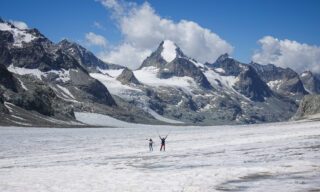 LHOers on the dry Otemma Glacier as they approach the Cabane de Vignettes during the Chamonix to Zermatt Haute Route Expedition with the Life Happens Outdoors team.