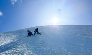 IFMGA guide Philippe Genin with veteran climber Haneen Alsliman during an icy day on the Naso del Lyskamm after the weather cleared up, during the Spaghetti Tour Expedition Climb Monte Rosa with the Life Happens Outdoors team.