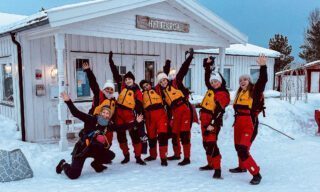 The LHO team preparing to kayak outside the café at Norwegian Wild on Senja Island during a Norway northern lights adventure tour.