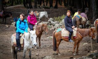 Life Happens Outdoors team on mules beginning the trail to Tiger’s Nest Monastery during a Bhutan adventure tour