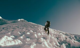 LHO climber Zeid Shair ascending the second set of fixed ropes on the way to the summit of Lobuche East, surrounded by ice pinnacles formed on the glacier due to wind and dry conditions.
