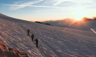 Traversing the Glacier du Trient at sunrise on the way to Aiguille du Tour during the Mont Blanc Summit Climb course with the Life Happens Outdoors team.