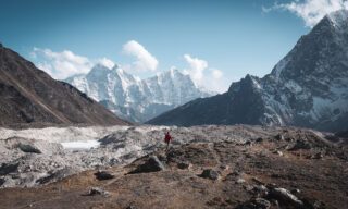 LHO team member walking outside Lobuche tea house, enjoying the view of the lower Khumbu Glacier.