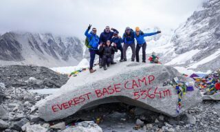 The Life Happens Outdoors team on the iconic EBC boulder upon reaching Everest Base Camp