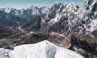 LHO climber beneath the summit of Lobuche East, waiting for the guide to assist on the final fixed rope to the summit, with the stunning Pheriche Valley below.