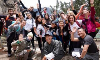 Life Happens Outdoors team with local guides gathered just before reaching Tiger’s Nest Monastery during a Bhutan adventure travel experience