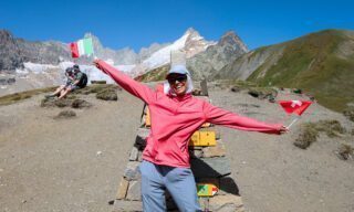 The Life Happens Outdoors team at the Grand Col Ferret on the Swiss-Italian border with Mont Dolent in the background during the Tour du Mont Blanc (TMB).