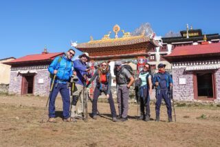 The Life Happens Outdoors Team posing in front of a Buddhist temple during the Everest Base Camp Trek