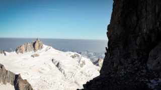 The Life Happens Outdoors team climbing the Dent du Géant with the Aiguille du Midi and the Vallée Blanche visible in the background during the Climb Matterhorn Course with the Life Happens Outdoors team.