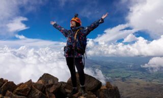 Nada Abanda on the summit of Iliniza Norte during the Climb Cotopaxi & Climb Chimborazo Expedition with the Life Happens Outdoors team.