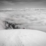 The Life Happens Outdoors team disappearing into the clouds as we descended Cotopaxi during the Climb Cotopaxi & Climb Chimborazo Expedition.