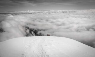 The Life Happens Outdoors team disappearing into the clouds as we descended Cotopaxi during the Climb Cotopaxi & Climb Chimborazo Expedition.