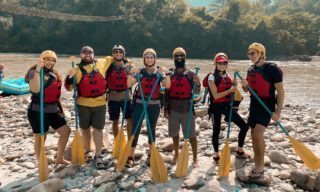 Life Happens Outdoors team and yoga guru preparing to raft white water rapids on a Nepal adventure holiday