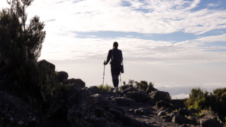 Life Happens Outdoors climber making the early morning descent from Horombo Hut to Mandara Hut after summiting Mount Kilimanjaro.