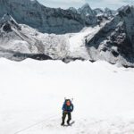 Roberto David abseiling down the headwall of Island Peak with the towering summit of Makalu in the background.