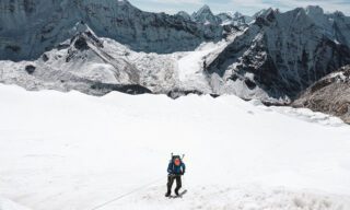 Roberto David abseiling down the headwall of Island Peak with the towering summit of Makalu in the background.