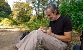 Life Happens Outdoors adventurer journaling reflections under a tree during downtime on a Nepal adventure holiday