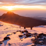 Sunrise on the summit during the Climb Kilimanjaro Expedition with the Life Happens Outdoors team.