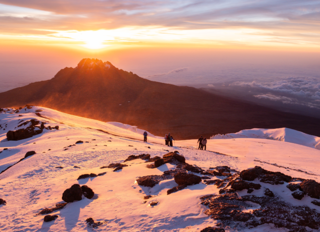 Sunrise on the summit during the Climb Kilimanjaro Expedition with the Life Happens Outdoors team.