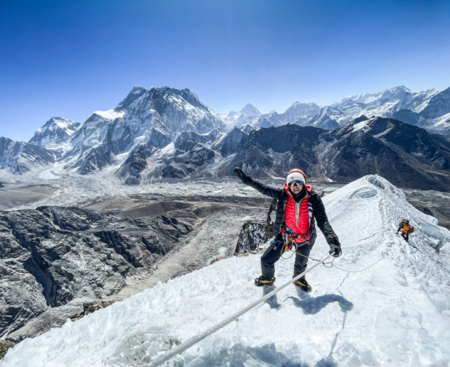 LHOer Melissa Jeffries on the summit during the Climb Lobuche East Expedition with the Life Happens Outdoors team.