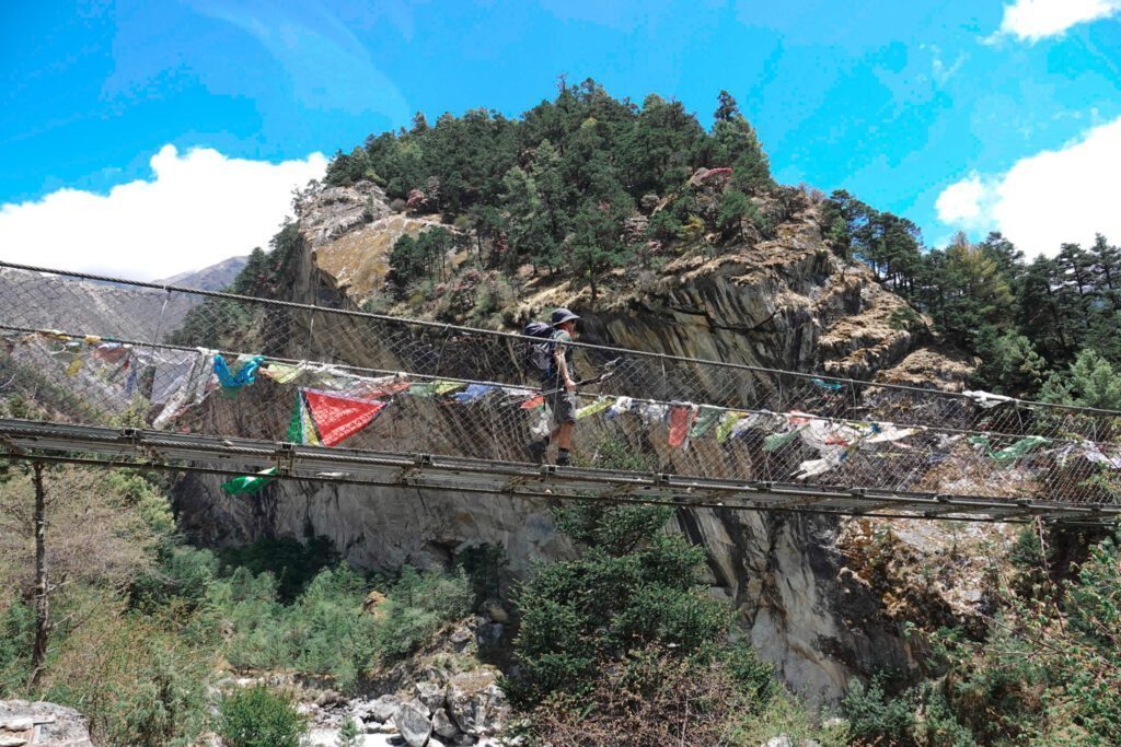 The Life Happens Outdoors team crossing a suspension bridge between Namche Bazaar and the Tengboche Monastery during the Everest Base Camp Trek.